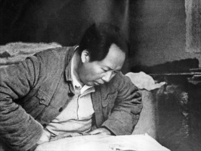 Chairman mao working in a peasant cottage at wangchiawan, northern shensi, during the time of the civil war against the chiang kai-shek regime.