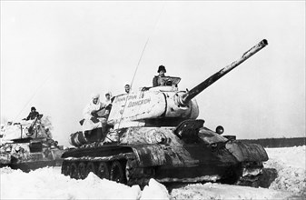 World war 2, soviet t-34 tanks in snow, front tank is named 'dimitry donskoy'.