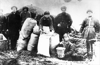 Workers brigades removing grain hidden by kulaks in stavropol, ussr, 1930.