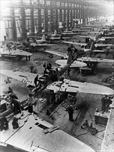 Il-2 sturmovik attack aircraft being built at a factory in the ussr during world war ll.
