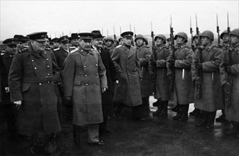 Moscow conference, winston churchill, stalin, and molotov passing an honor guard prior to the departure of the british delegation.