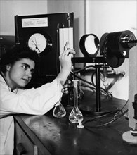 A young woman performing an experiment at the peat science laboratory at the higher school of rural economy in warsaw, poland may 1964, there are now more than three times more academic schools than b...
