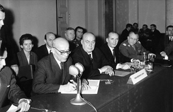 The head of the polish delegation, wladislaw gomulka (left), signing the joint communique at the conclusion of the warsaw pact talks in the conference hall, warsaw, poland, 1955.