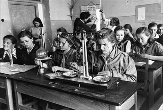 Young women students learning chemistry at the workers friends of polish children teachers' school in warsaw, poland, 1949.