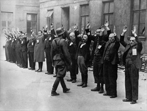 World war 2, a nazi ss officer inspecting a group of jewish workers in warsaw, poland in the late 1930s.