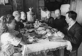 A family at breakfast on the 'pobeda' collective farm, august 1948.