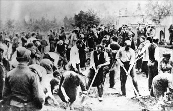 World war 2, ukrainian jewish civilians, including women and children, being forced by the nazis to dig their own common grave prior to their execution in july 1941.