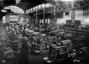 Pilot soviet-made semi-automatic textile machines are being assembled at the karl marx factory, leningrad, soviet union, 1924.