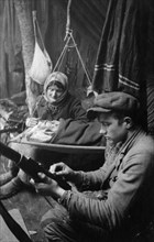 A young partisan cleaning his rifle in western byelorussia, world war 2.