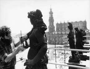 Sculptor peter flade, one of many craftsmen working on the restoration of the semper opera house in dresden, germany which was destroyed by bombing, 1978, this is part of an on-going effort to rebuild...