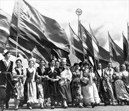 Sixth world festival of youth and students in moscow, july 28, 1957, delegates of the soviet union, representing all 15 republics, marching in lenin stadium during the opening ceremonies.
