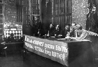 Comrade solovyov, the secretary of the communist party branch at the krasny putilovets plant, undergoing questioning duing the campaign to cleanse the cp of hostile elements, leningrad, 1933, the bann...