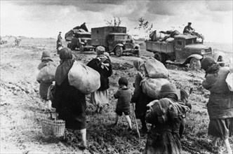 World war 2, civilian refugees walking east, past red army troops heading west to the front to counter the german advances in july 1941.