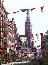 Street in gdansk, poland with the city hall clock tower in the background, 1965.