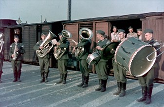 German army band playing at the embarkation point, occupation zone unknown, photo taken by an unknown german soldier.