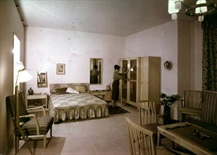 A design for a sitting and bed room of the young worker by interior decorator, laszlo hornicsek, at the third hungarian handicraft and folk-art exhibition, 1950s.