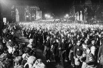 A torchlight procession of free german youth organization members in honor of the 35th anniversary of the gdr on unter der linden avenue in berlin, october 10, 1984.