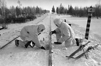 Soviet paratroopers in the enemy's rear, sappers placing mines under railway track, january 1942.