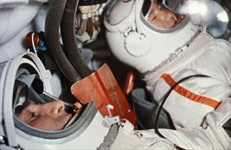 Soviet cosmonauts alexey leonov (right) and pavel belyayev in the cabin of the voskhod 2 spacecraft prior to take-off, 1965.