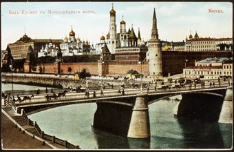 A pre-1917 color postcard depicting the moskvoretsky bridge and the moscow kremlin beyond.