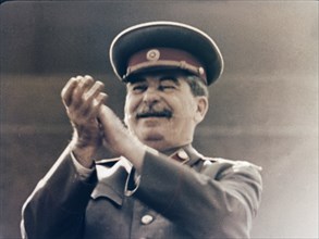 Joseph stalin applauding the red army during a may day parade in red square in 1949.
