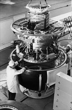 Technicians assembling the venera descent module of the soviet space probe vega at the baikonur cosmdrome, 1984.