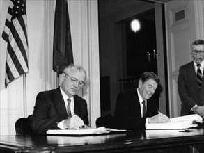 Mikhail gorbachev and ronald reagan, signing the treaty between the usa and the ussr on the elimination of intermediate and short-range missiles, in the white house on december 8, 1987.