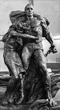 The two central figures, in bronze, of a monument to soviet civilians and soldiers who perished in the fascist concentration camp in mauthausen, austria, the monument, designed by v, tsigal of moscow ...