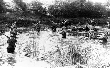 Soviet soldiers of the 2nd baltic front force a crossing over a river approaching riga, august 1944.