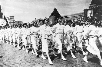 Ukrainian sportswomen participate in a sports parade in red square, moscow, ussr, 1930s.
