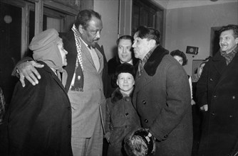 Paul robeson and his wife eslanda being greeted at vnukovo airport by m, kotov, executive secretary of the soviet peace committee, and soviet writers b, polevoi and v, zakharchenko, moscow, ussr, janu...