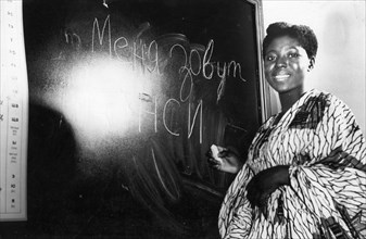 A nigerian student writing 'my name is nancy johnson' in russian during the start of classes at the peoples' friendship university in moscow, october 1, 1960.