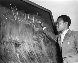 Nigerian student gotfrid pata writing his first russian word 'mir' (peace) during the start of classes at the peoples' friendship university in moscow, october 1, 1960.