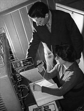 Chief engineer j, skrins and technician m, kovalyeva checking over blocks of a besm-2 computer installed at the new computing center at latvia's p, stuchki state university in riga, 1961, this center ...
