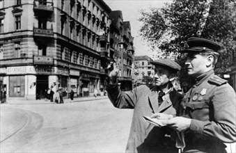 Commandant of a section of a section of the schoeneberg district of berlin, major grobov, accompanied by a representative of the burgermeister erich kobyliatski, inspecting the district, june 1945.