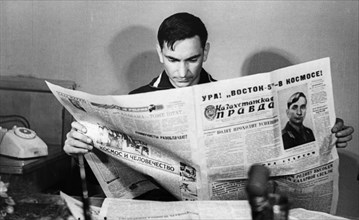 Soviet cosmonaut, lieutenant-colonel valeri bykovsky reading about himself in kazakhstanskaya pravda after his return from the vostok 5 space mission, june 1963.
