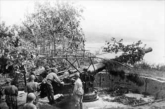 Soviet artillerymen preparing for fight under the dying away sounds of the military alarm during the defence of hanko peninsula, south west of finland, on baltic sea.
