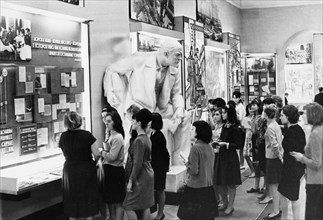 Visitors looking over items in the exhibition 'the triumph of the great ideas of leninism' at the central lenin museum in moscow, 1966.