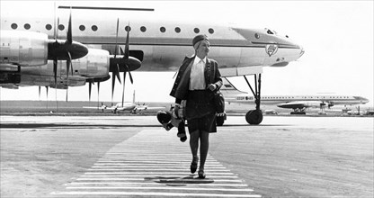 Stewardess inessa kirjavainen and her plane, the tu-114, at domodedevo airport, moscow, august 1968.