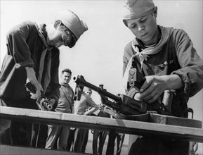 Soviet pioneers during a competition to be the quickest to to dismantle and reassemble a gun, moscow, july 1969.