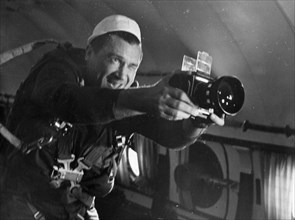 Cosmonaut anatoly filipchenko, commander of soviet space mission soyuz 7, in weightless training, with a camera, ussr, 1969.