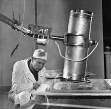Luna 16, a scientist testing the boring mechanism of the luna 16 lunar lander in the laboratory, october 1970.