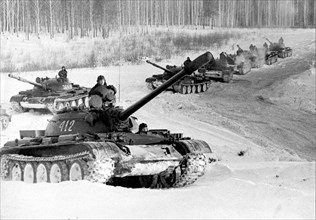 Soviet army, april 1971, t-55 tanks crossing a snowy terrain during military exercises.