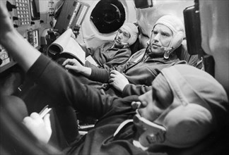 Soviet cosmonauts (l to r) flight engineer alexei yeliseyev, commander vladimir shatalov, and test engineer nikolai rukavishnikov in the cabin of the soyuz 10 spacecraft, april 1971.