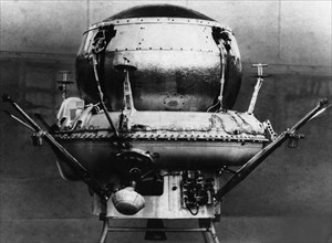 The landing capsule of the soviet space probe, mars 3 in the assembly shop, the parachute container is seen on top along with the opening system installed, on the sides are bars for fastening the brak...