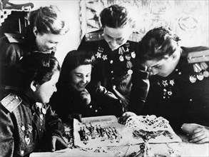 Soviet women's squadron, soviet women pilots, world war 2, left to right: squadron navigator yekatrina (katya) ryabova; flight commander raisa yushchina: navigator mira paromova; squadron commanders n...