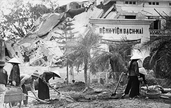 People clearing the grounds of the bach-mai hospital in hanoi after it was completely destroyed by american air raids in december 1972.