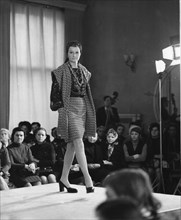A model shows a new jacket and skirt combination at a fashion show, moscow, ussr, 1973.