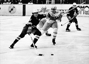 A juniors hockey match between the soviet army team of leningrad and the verdun maple leafs of canada, s, vasilyev (left) fighting for the puck, f, bernard (center) and v, pribylov (right), march 1974...