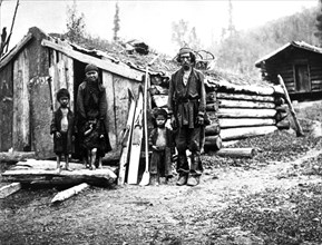 Gorno-altai region, siberia, russia, 1912, a peasant family outside their one room log hut (izba).